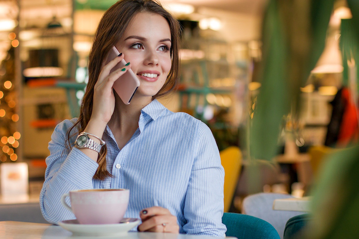 Frau telefoniert in einem Cafe